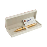 Gold pen in an open box with a card inside, on a white background