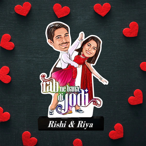 Unique Love Story Gift with Bollywood-style caricature of a couple, red hearts background, and custom names on a durable acrylic stand.