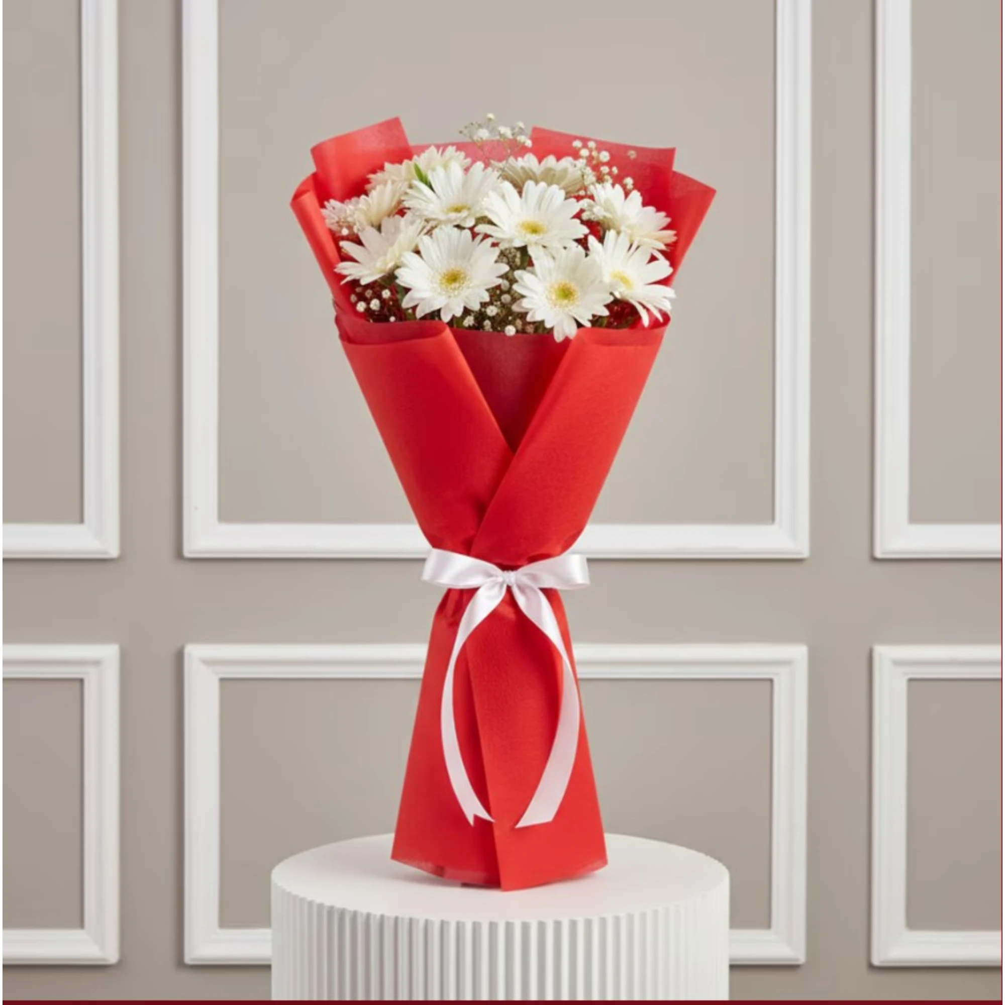 White daisies bouquet with red wrapping