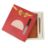 Gift set with red box, brown leather item, and pen on a white background