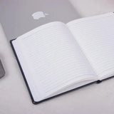 Black Fluct A5 Diary open to reveal lined pages, ideal for notes and journaling.