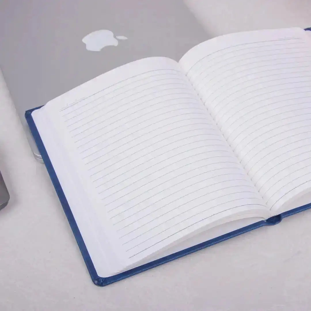 Blue Primo A5 Diary - Productivity Planner | 192 Pages open on a desk beside a laptop, ideal for office use, journaling, or corporate gifting.