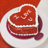 Heart shape cake with red velvet sponge, cherry filling, and 'I LOVE U' icing, ideal for Valentine's Day or romantic celebrations.