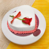 Valentine heart shape vanilla cake topped with a fresh red rose, perfect for romantic celebrations and same day delivery gifting.