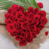 Perky Blooms - Pink Roses Delivery | Valentine's Day Gifts Online featuring a heart-shaped arrangement of fresh red roses on burlap with palm leaves.