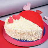 Red Velvet Heart Shaped Cake - Lovers Day Cakes Online featuring half red velvet crumbs and half vanilla cream with white chocolate shavings.