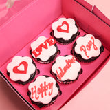 Happy Valentines Day Cupcakes - heart shaped red velvet 6 cupcake box with white fondant and red icing text in pink packaging.