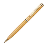 Gold pen with textured body on a white background