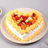 Delectable Valentine Heart Cake topped with fresh fruits and vanilla cream, perfect for Valentine's Day celebrations and same day delivery.