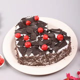 Heart Shape Black Forest Cake with pineapple flavor topped with cherries and chocolate shavings, perfect for Lovers Day celebrations.