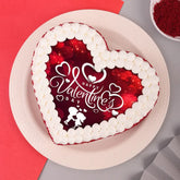 Red Velvet Valentines Poster Cake - Valentine Heart Shaped Cake with white cream border and romantic design, perfect for gifting on Valentine's Day.