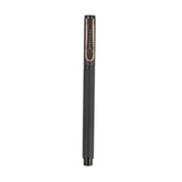 Black pen with rose gold accents on a white background