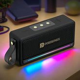 Black portable speaker with colorful LED lights on a wooden surface, featuring the Portronics brand.