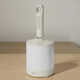 White cleaning tool with a handle on a wooden surface