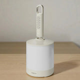 White cleaning tool with a handle on a wooden surface