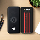 Black power bank with red cable heads on a wooden surface