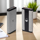 Two power banks on a desk with a plant in the background