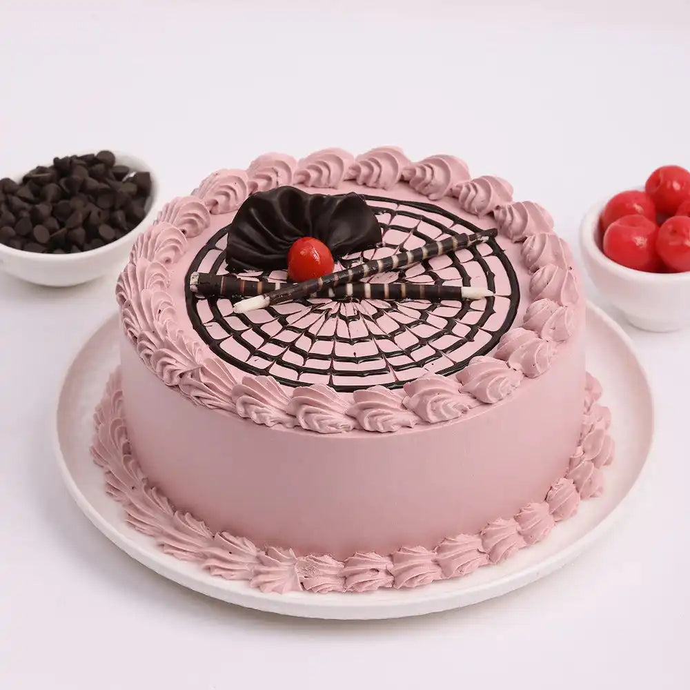 Chocolate Glory Cake - Rich Cake with pink cream frosting, chocolate garnish, and cherry topping, ideal for birthdays and anniversaries.