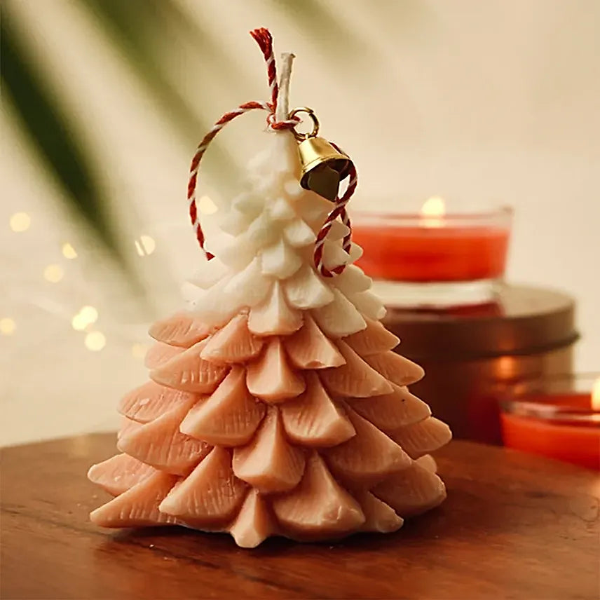 Festive orange glow Christmas tree candle with pine scent, ideal for Christmas décor and cozy seasonal ambiance.