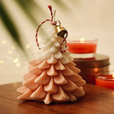 Festive orange glow Christmas tree candle with pine scent, ideal for Christmas décor and cozy seasonal ambiance.