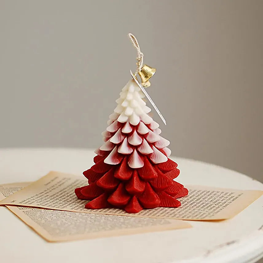 Red and white Christmas Glow Tree Scented Candle displayed on vintage pages, ideal for Christmas gifts and seasonal home fragrances.
