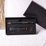 Black pen, keychain, and pen holder set with 'Jayant' engraving in a box on a white surface.