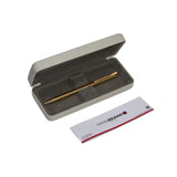 Gold pen in an open beige case with a 'Swiss Brand' card on a white background