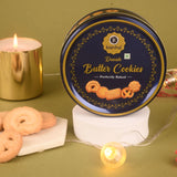 Kanha Danish Butter Cookies tin with cookies and a candle on a green background