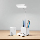 White desk lamp with a pen holder on a wooden surface