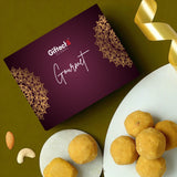 Gifteek gourmet box with a plate of yellow treats and nuts on a green background