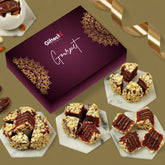 Gourmet chocolate truffles in a decorative box with a gold ribbon on a brown background.