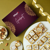 Gourmet dessert box with powdered sugar topping on a plate, surrounded by nuts and a decorative ribbon.