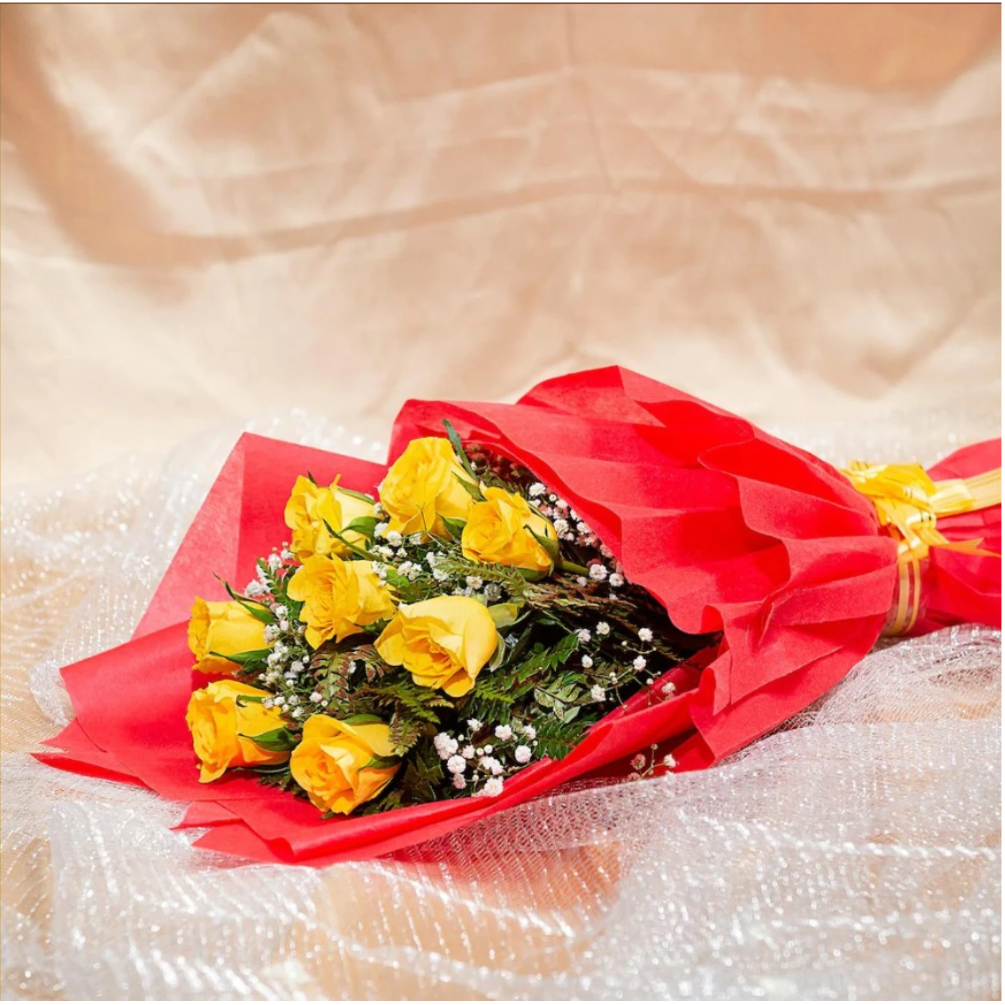 Close-up of yellow roses bouquet with red wrapping