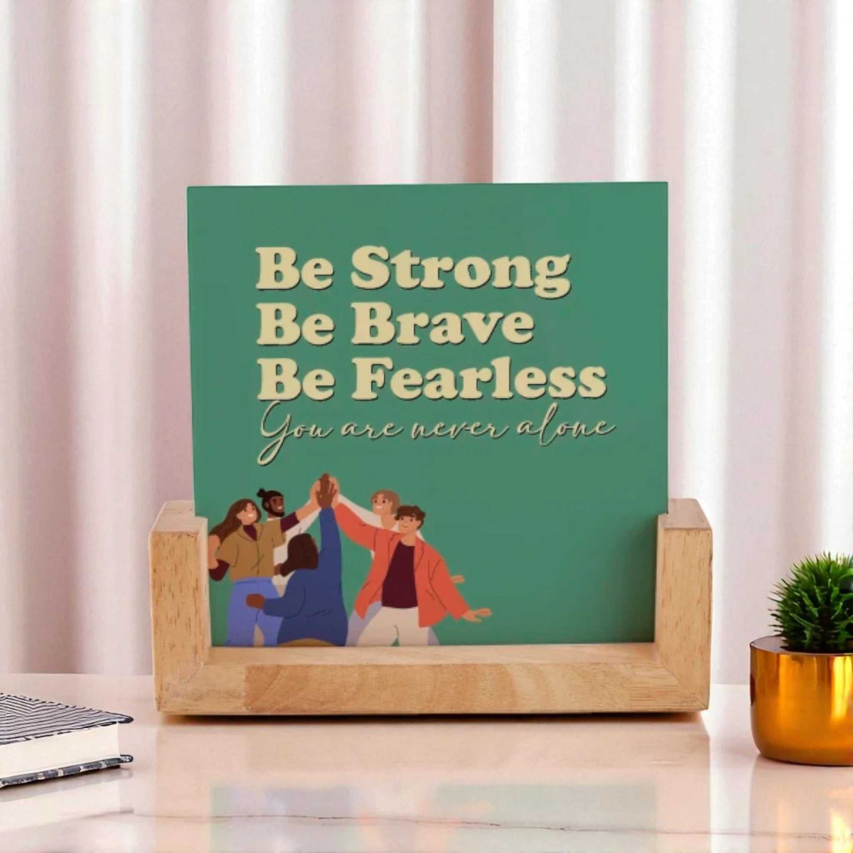 Double-sided frame with motivational quote 'Be Strong, Be Brave, Be Fearless' on green background, set in a wooden base for desk display.