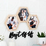 Hexagon Trio Photo Wall Frame Set - Best Of Us displayed on a white wall, featuring three wooden frames with couple photos and decorative text.