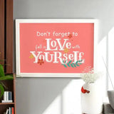 Love Yourself First Frame - Self-Love Gift displayed on grey wall, perfect for home & garden decor or personalized gift ideas.