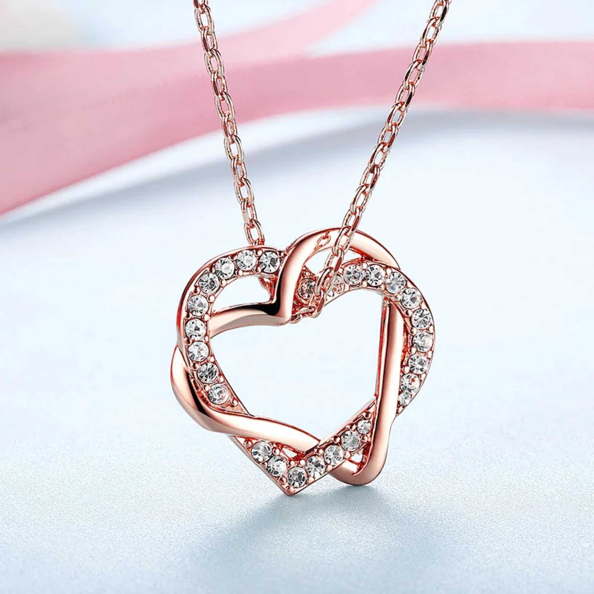 Elegant rose gold heart pendant with crystal accents on a delicate chain, perfect for romantic or special occasion gifts.