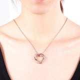 Rose gold heart pendant necklace worn on model, showcasing a minimal and elegant design with embedded crystals, ideal for gifting.
