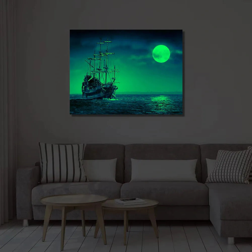 Night view of Gleaming Delight Night Glow Frame 12x16 illuminating a living room with a glowing ship and moon, perfect for home décor ambiance.