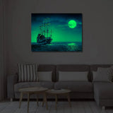Night view of Gleaming Delight Night Glow Frame 12x16 illuminating a living room with a glowing ship and moon, perfect for home décor ambiance.