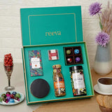Open Graceful Indulgence Hamper showcasing luxury chocolates, granola, cookies, and hot chocolate in elegant packaging, perfect for Christmas or New Year gifts.