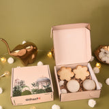 Gift box with decorative items on a green surface