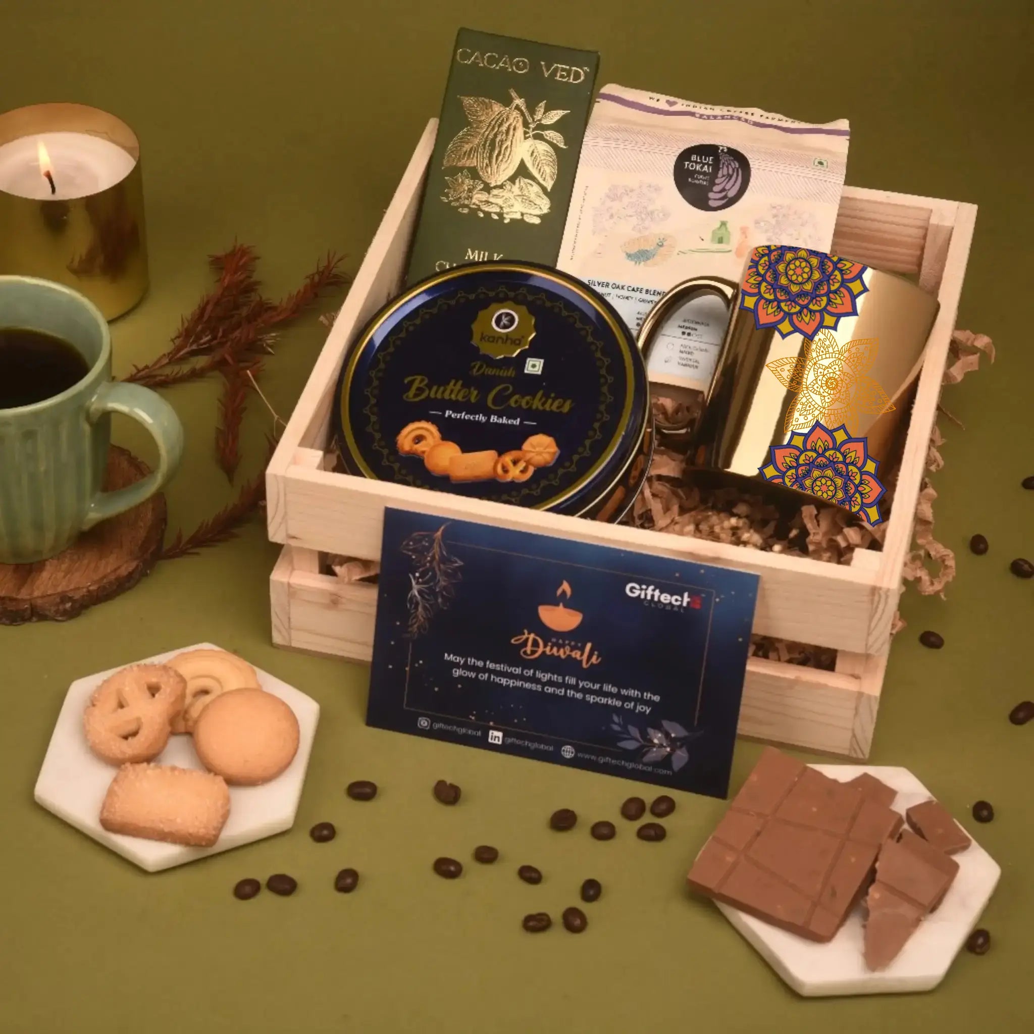 Gift basket with cookies, chocolate, and a candle on a green background