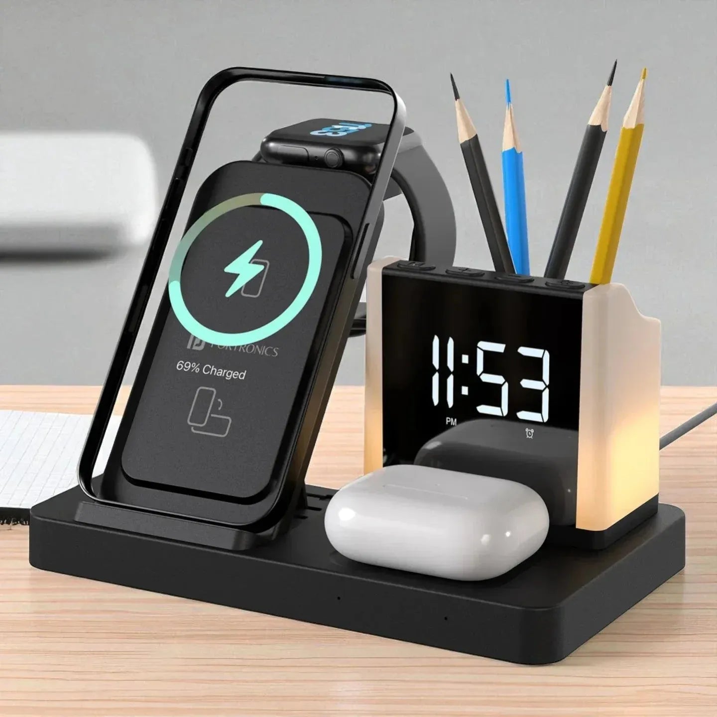 Desk organizer with wireless charger, digital clock, and pencil holder on a wooden surface.