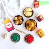 Holi gift hamper with herbal colors, sweets, and greeting card