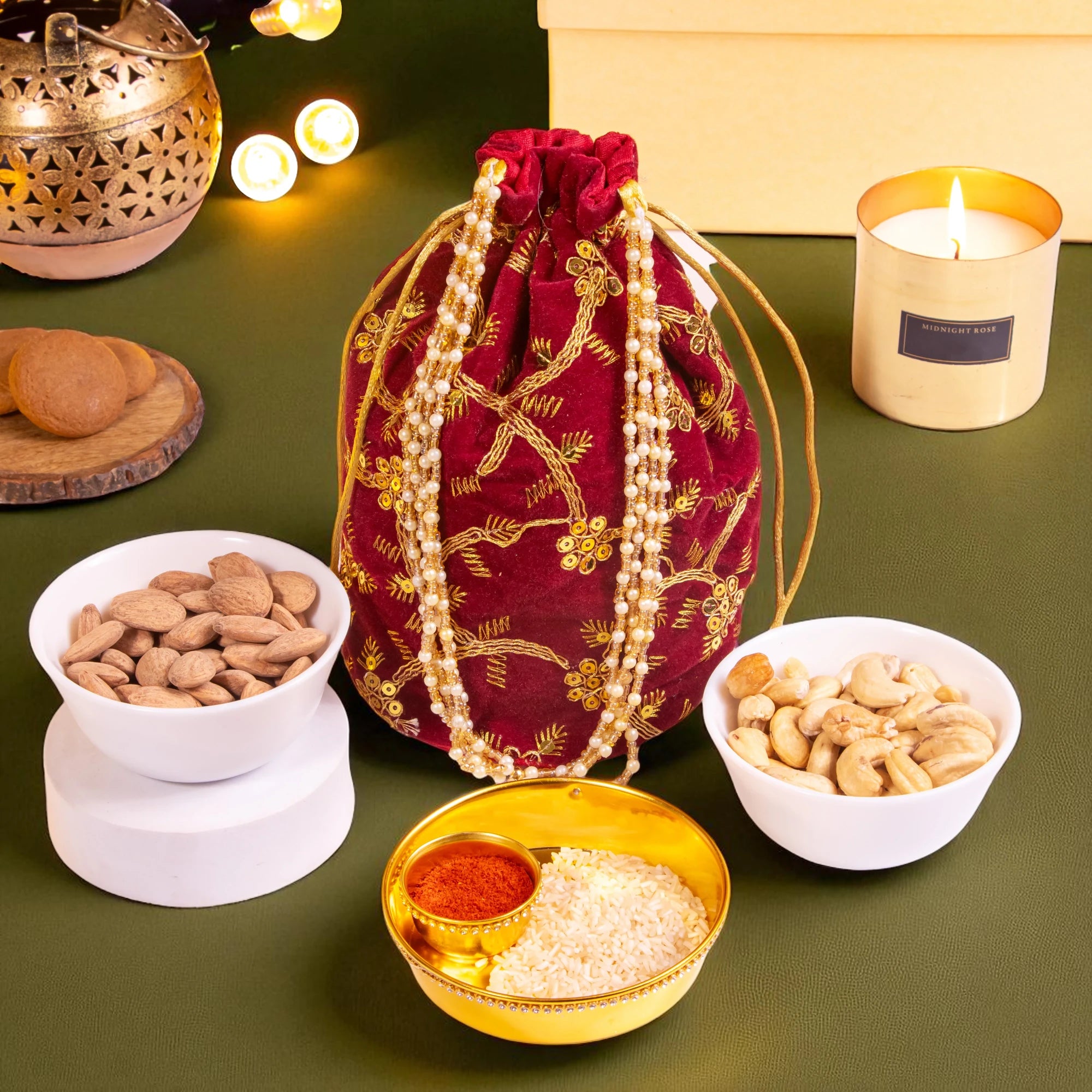 Traditional red velvet potli with dry fruits and pooja thali, included in the Eternal Diwali Hamper for employees and housewarming gifts.