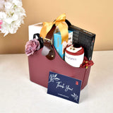 Elite Indulgence Hamper gift set with wellness and tech items neatly packed in a stylish maroon bag, ideal for corporate gifting.