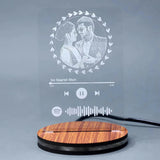 Acrylic engraved LED lamp for couples featuring custom photo and music code, set on a wood-textured base, perfect for anniversary gifts.