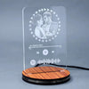 Personalized engraved LED couple lamp with acrylic panel and wooden base, showcasing a romantic photo and music-themed design.