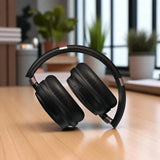 Black headphones on a wooden surface